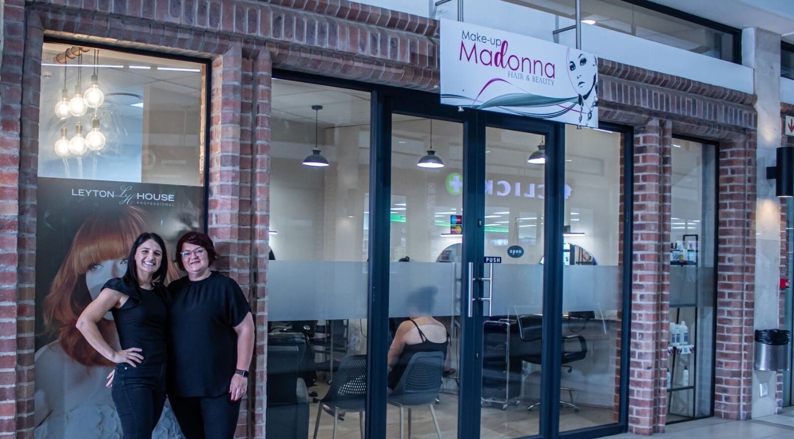 Ilze at Makeup Madonna's elegant entrance in Wellington, Western Cape, ZA with staff welcoming visitors.