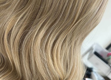 Blonde wavy hair styled at Studio Nine with Louise McEwan in Newport, England, GB, showcasing salon elegance.