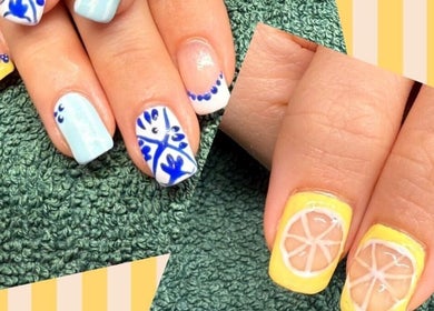 Vibrant nail art with lemon and floral designs at Polgooth Village Salon, Polgooth, England, GB.