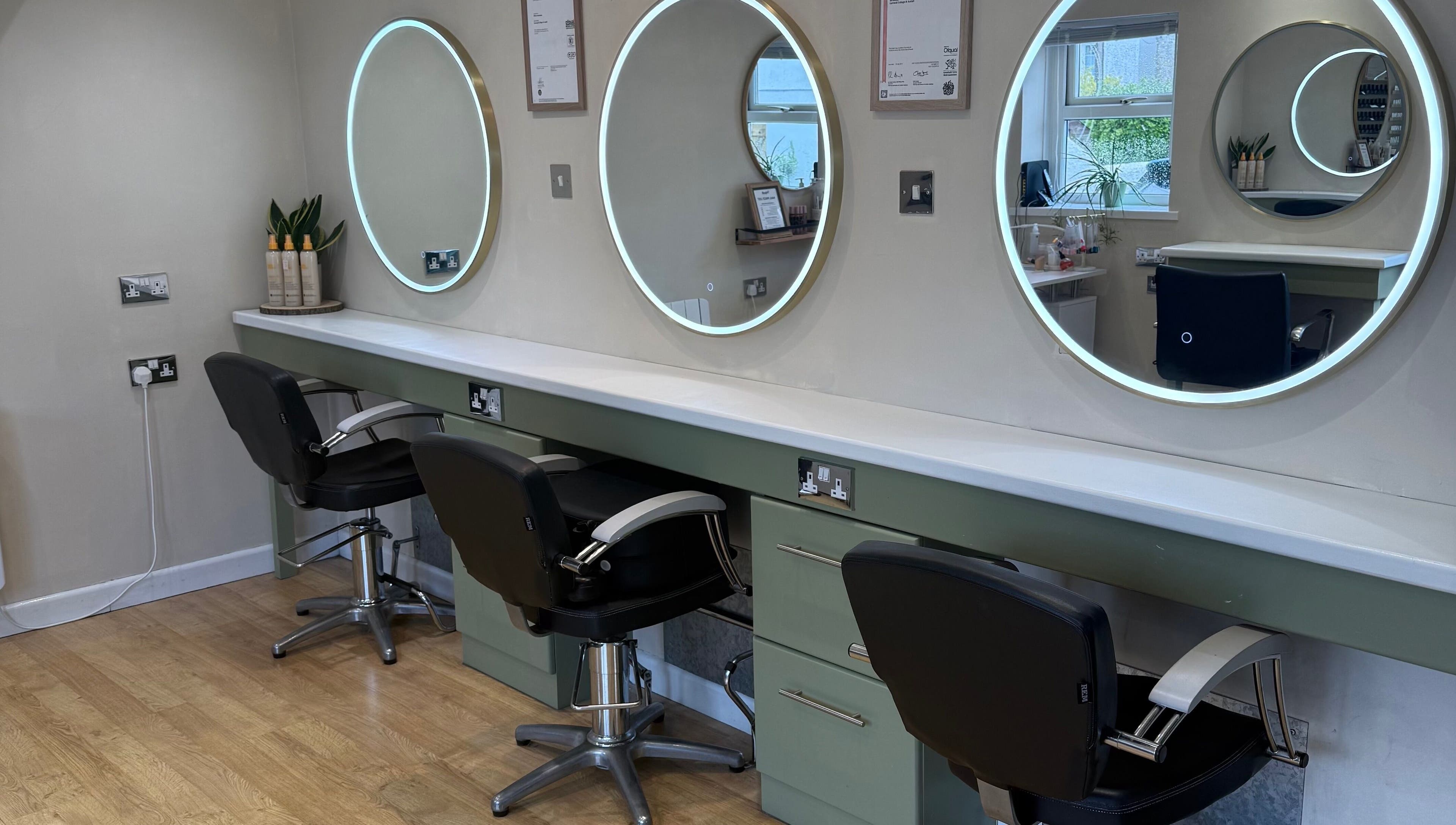 Chic styling stations with illuminated mirrors at Polgooth Village Salon, Polgooth, England, GB.