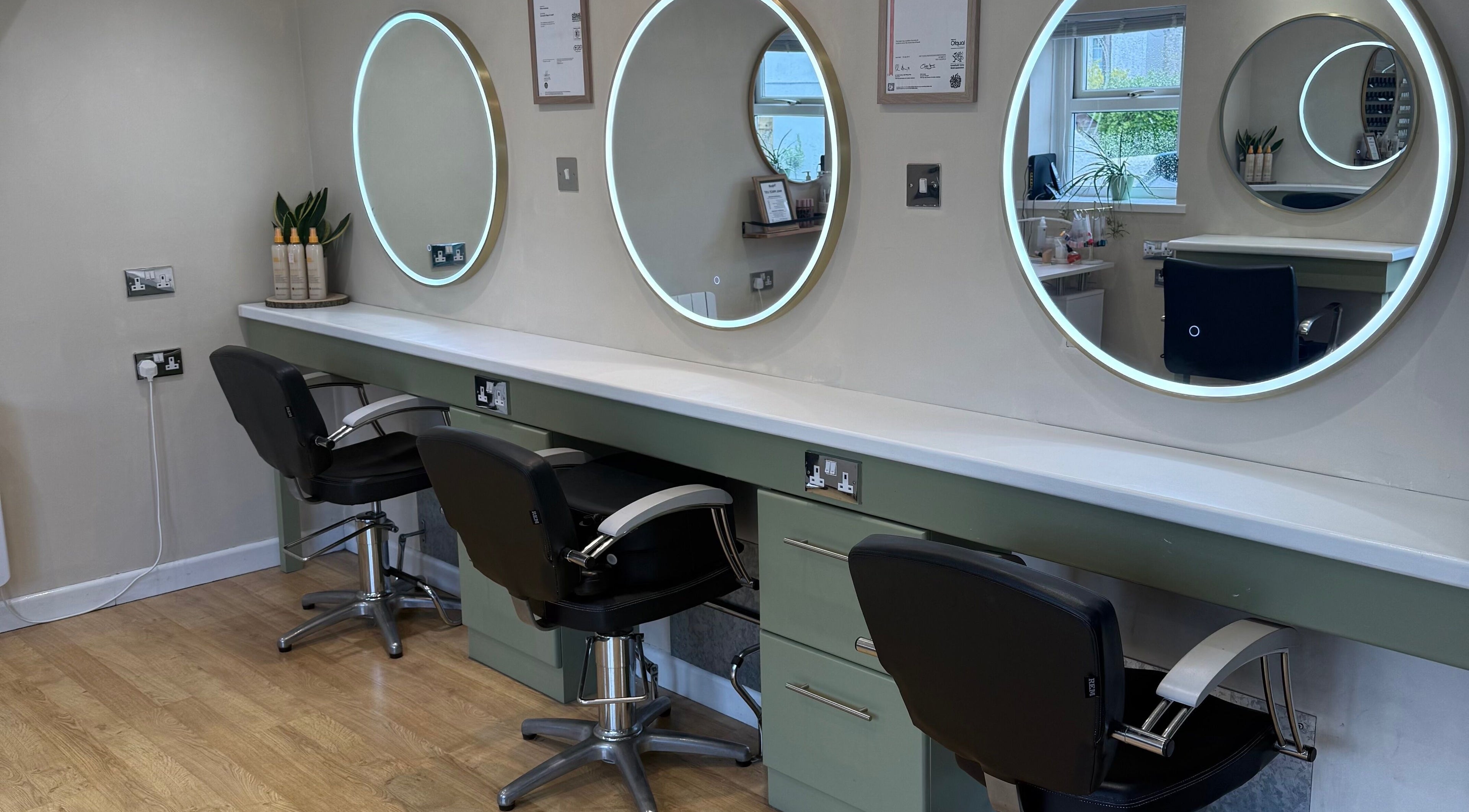 Chic styling stations with illuminated mirrors at Polgooth Village Salon, Polgooth, England, GB.