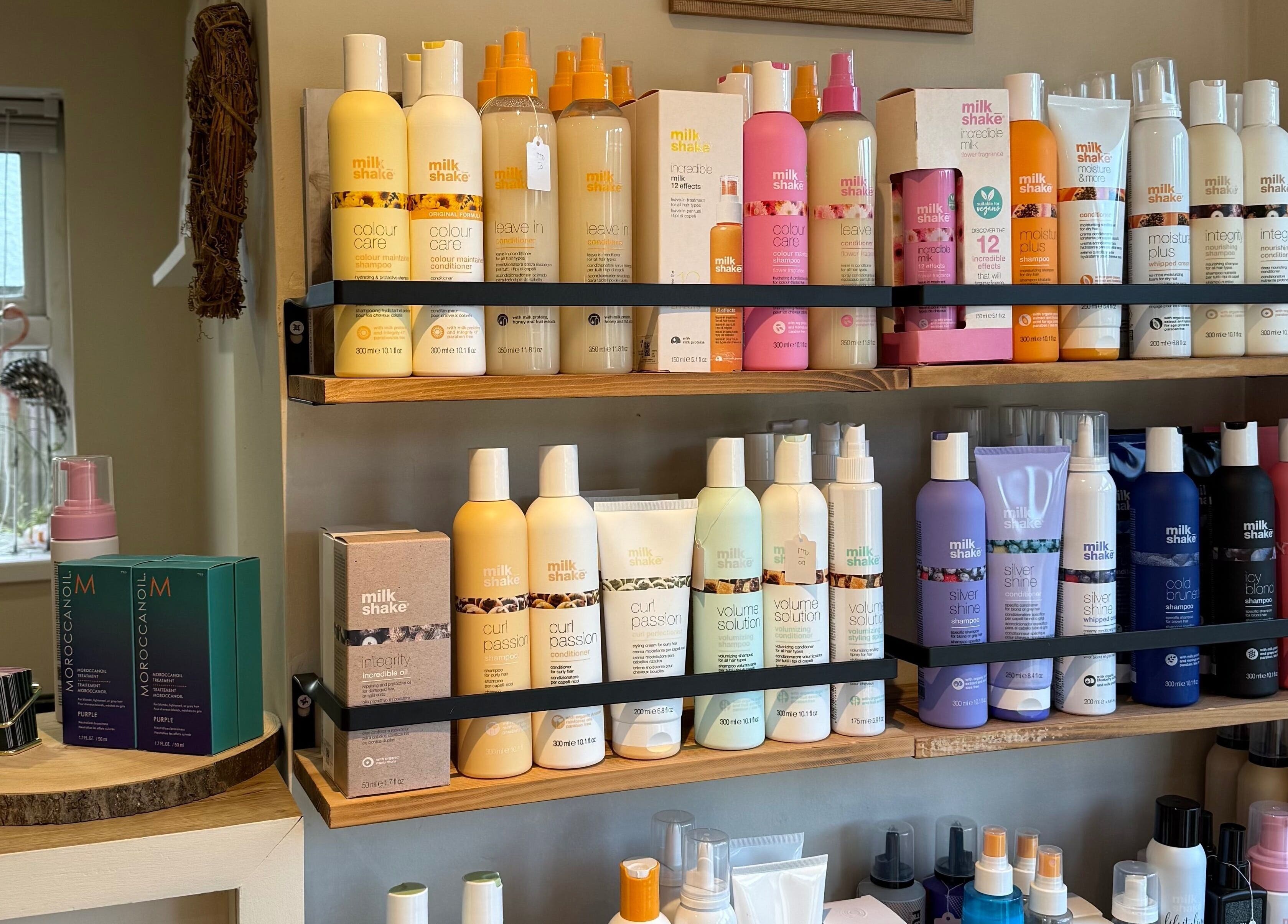 Shelf of haircare products at Polgooth Village Salon, Polgooth, England, GB showcasing popular brands.
