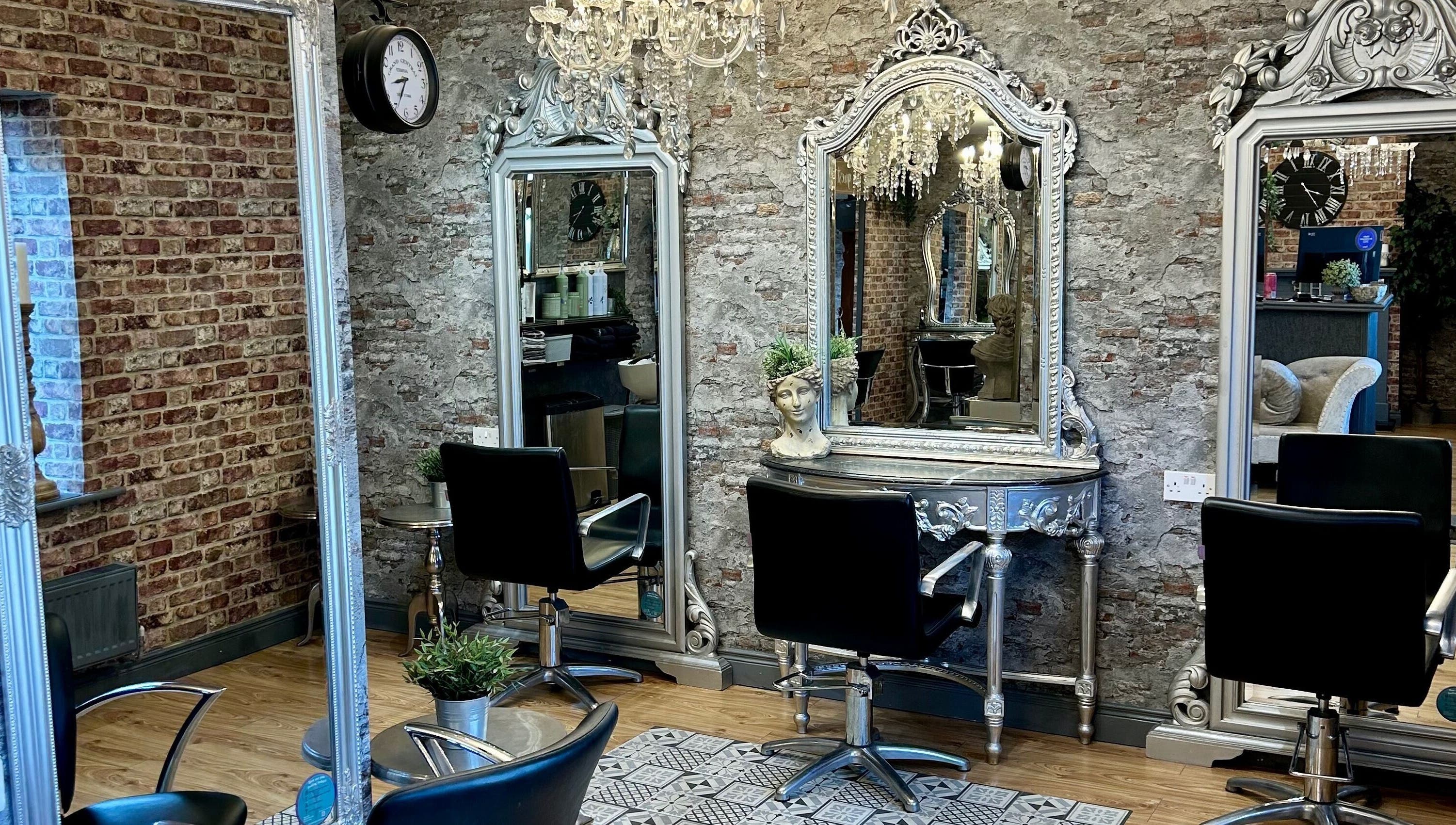 Chic and stylish salon interior at Hair Factory, Prosperous, County Kildare, IE with vintage mirrors and chairs.