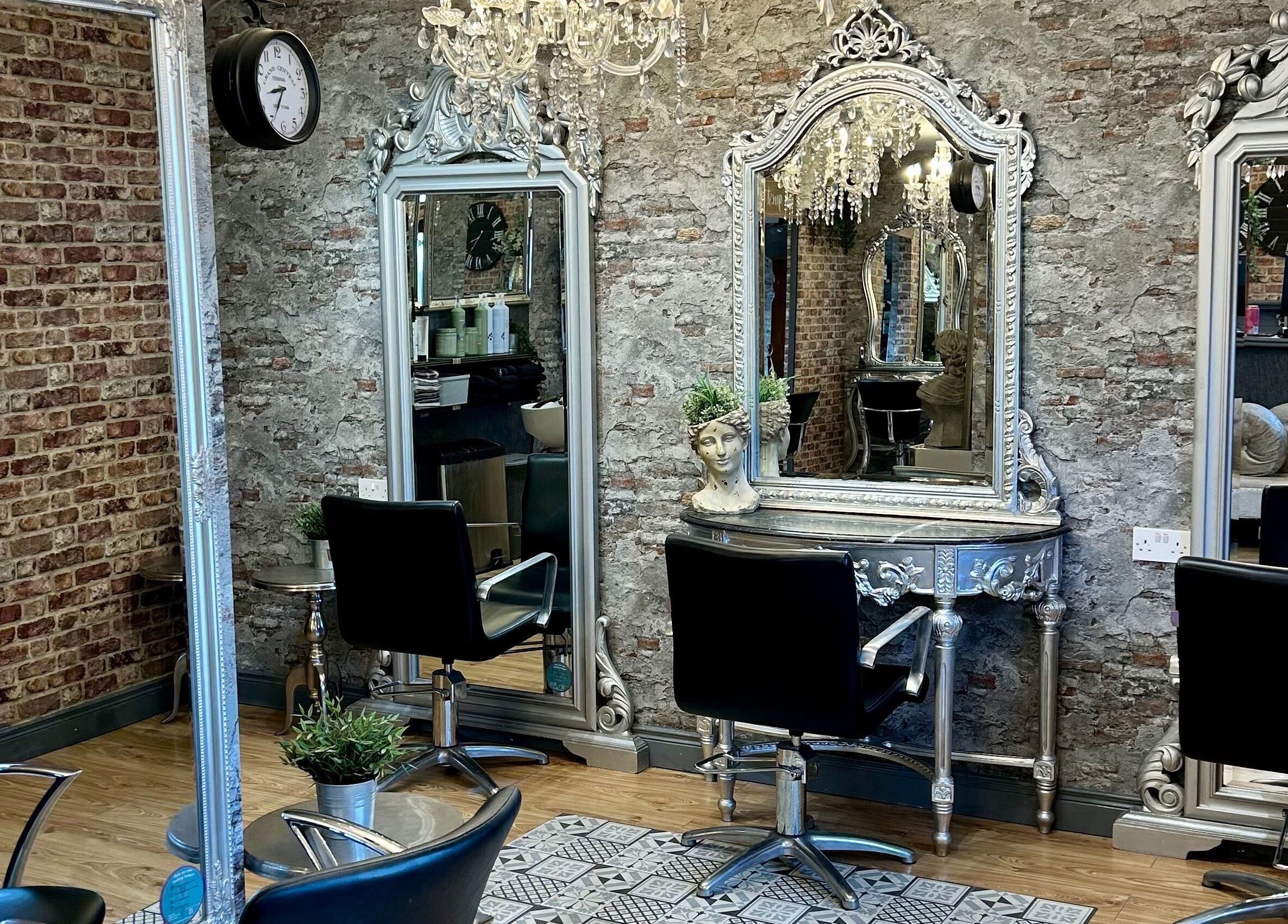 Chic and stylish salon interior at Hair Factory, Prosperous, County Kildare, IE with vintage mirrors and chairs.