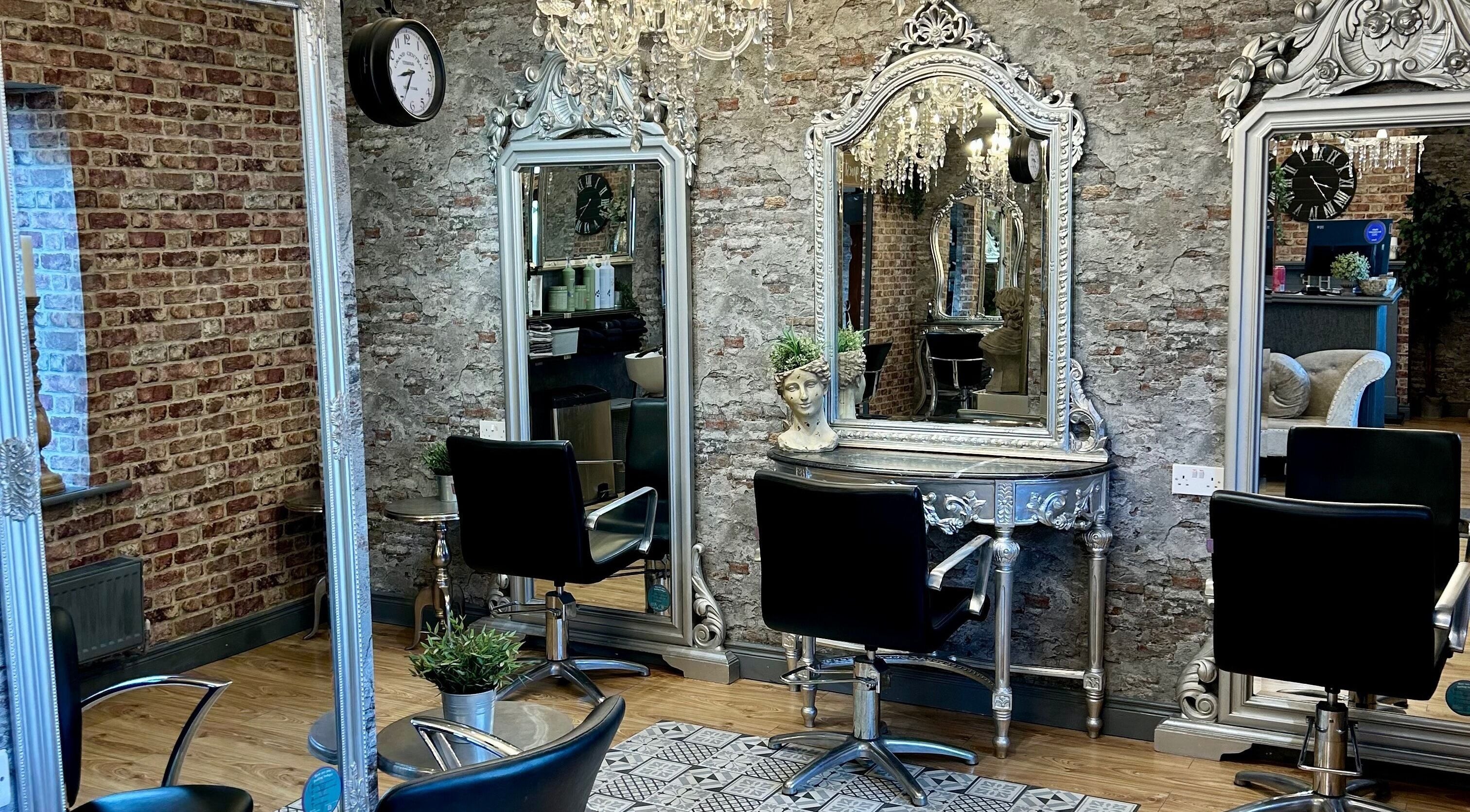 Chic and stylish salon interior at Hair Factory, Prosperous, County Kildare, IE with vintage mirrors and chairs.