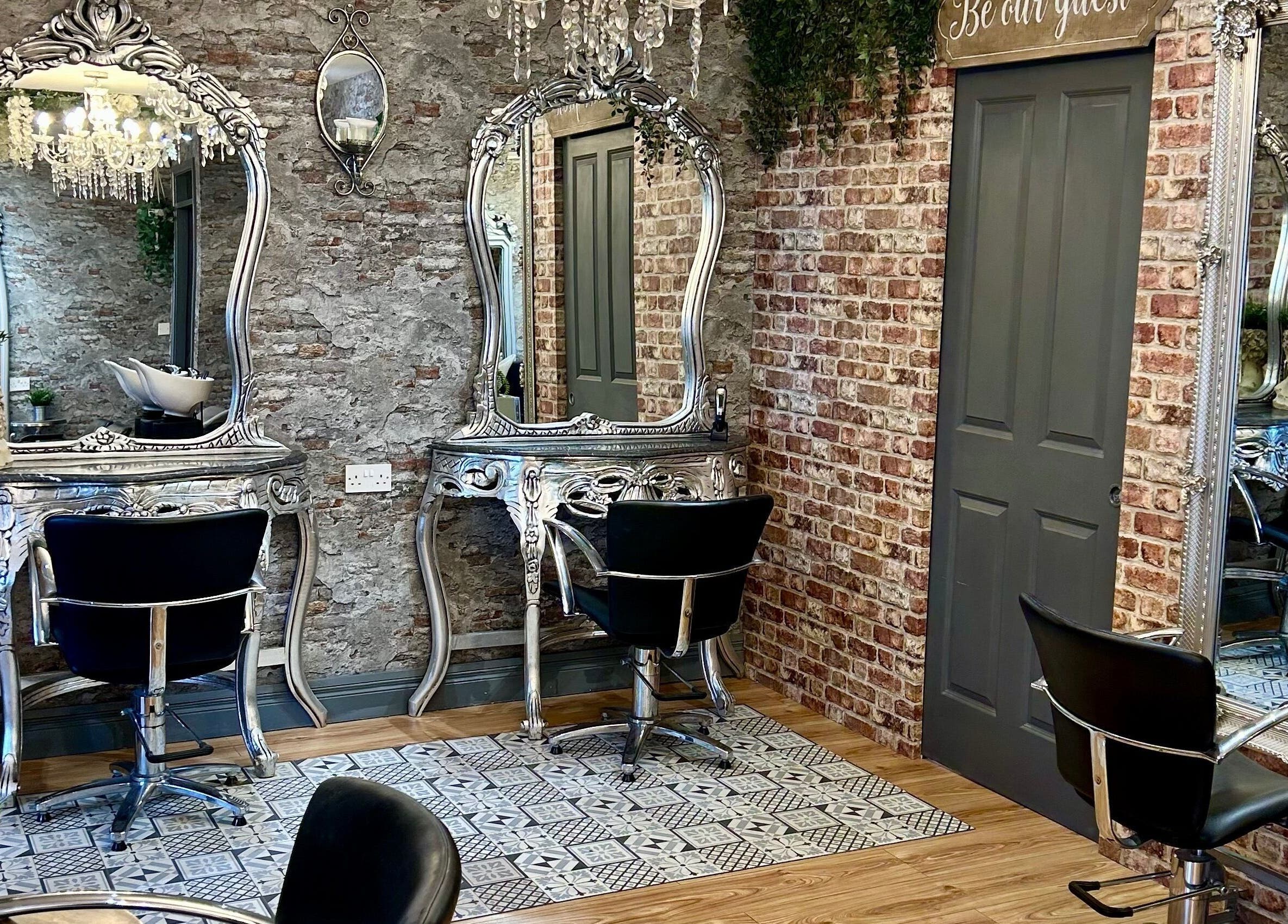 Elegant styling stations at Hair Factory, Prosperous, County Kildare, IE featuring ornate mirrors and chairs.