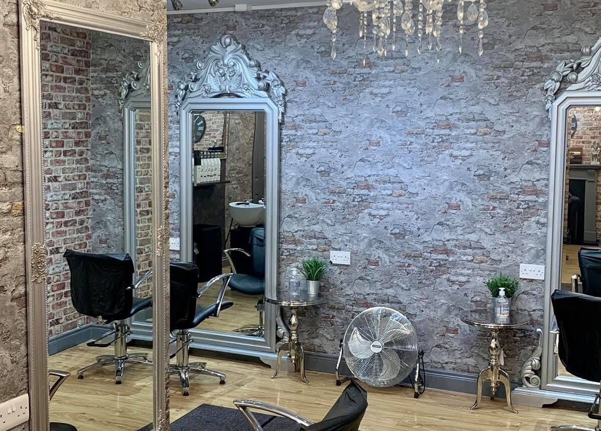 Elegant salon interior at Hair Factory, Prosperous, County Kildare, IE with stylish mirrors and chairs.