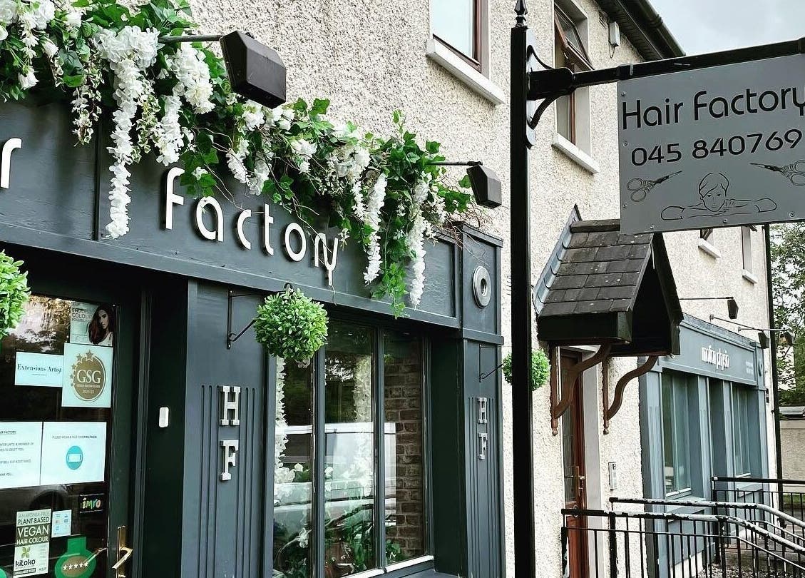 Entrance of Hair Factory in Prosperous, County Kildare, IE, adorned with greenery and stylish decor.