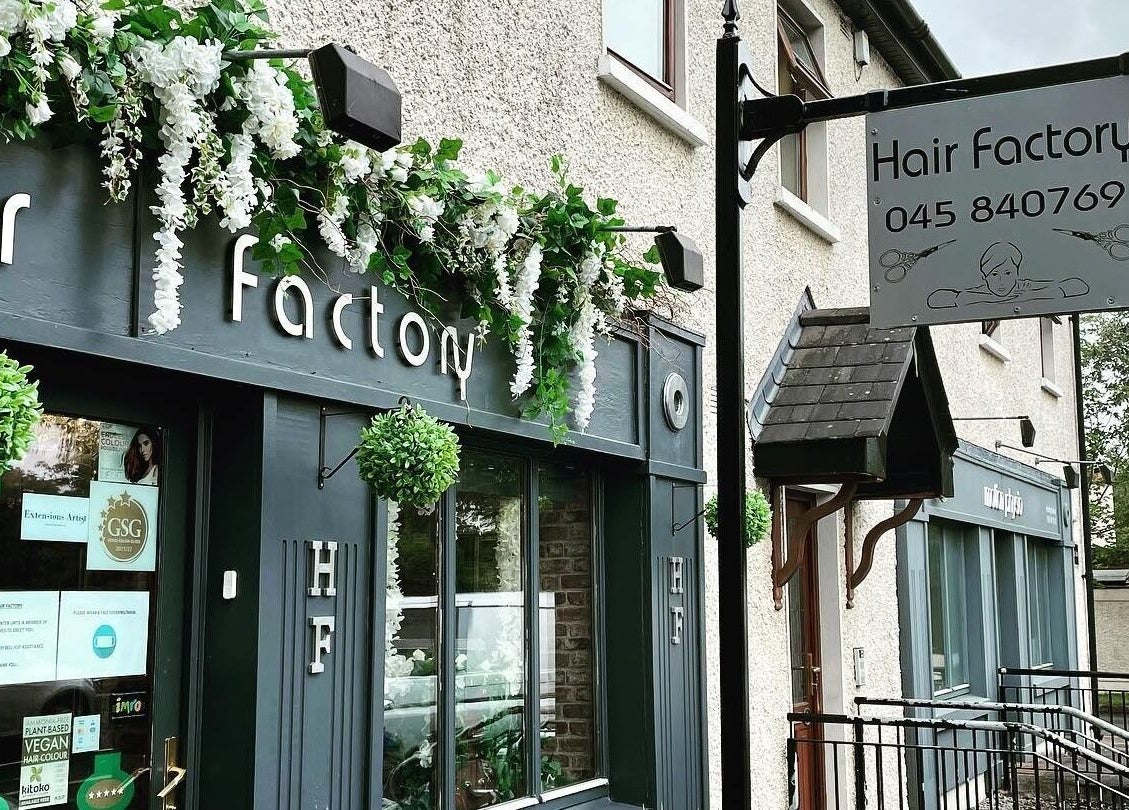 Entrance of Hair Factory in Prosperous, County Kildare, IE, adorned with greenery and stylish decor.
