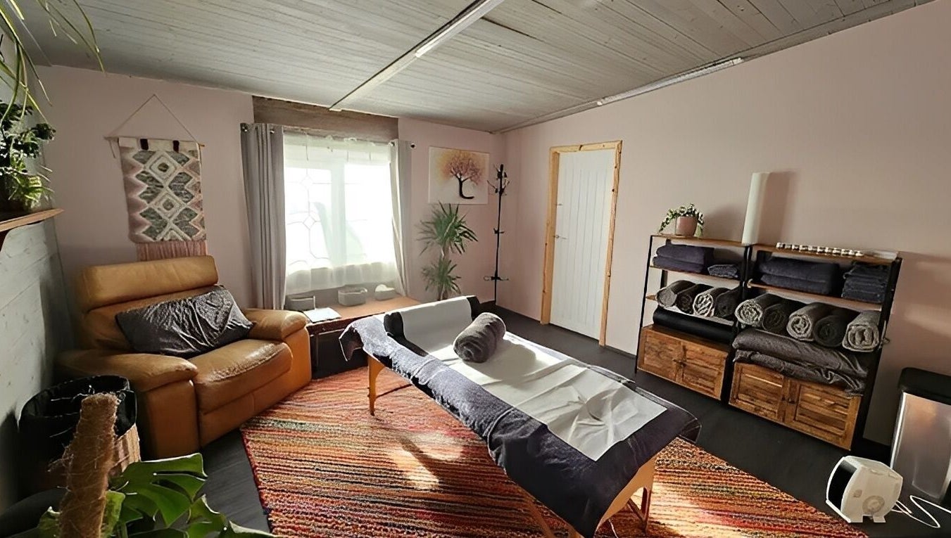 Relaxing massage room at The Muscle Medic, Walton Highway, England, GB with cozy decor and ambient light.