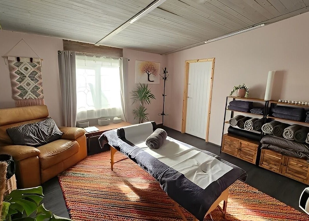 Relaxing massage room at The Muscle Medic, Walton Highway, England, GB with cozy decor and ambient light.