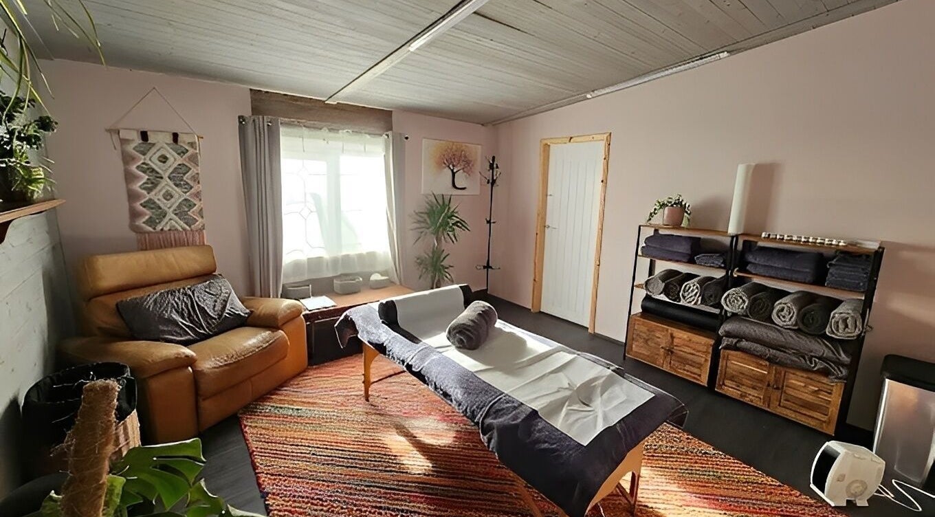 Relaxing massage room at The Muscle Medic, Walton Highway, England, GB with cozy decor and ambient light.