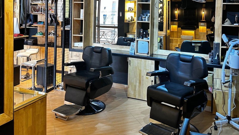 Modern interior of Etunganun Grooming and Beauty Lounge, Kira Town, Central Region, UG with sleek chairs and mirrors.