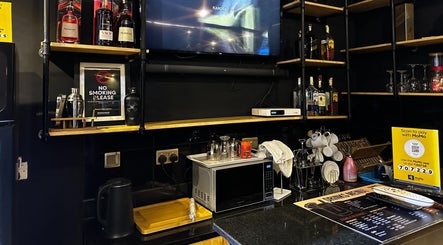 Chic bar area at Etunganun Grooming and Beauty Lounge, Kira Town, Central Region, UG with sleek shelves and decor.