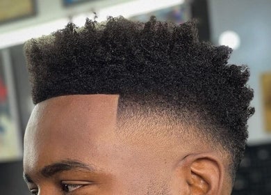 Close-up of a sharp fade haircut at Etunganun Grooming and Beauty Lounge, Kira Town, Central Region, UG.