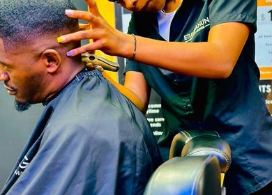 Professional haircutting service at Etunganun Grooming and Beauty Lounge, Kira Town, Central Region, UG.