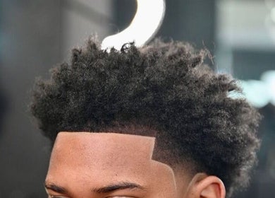 Close-up of a men's haircut at Etunganun Grooming and Beauty Lounge, Kira Town, Central Region, UG.