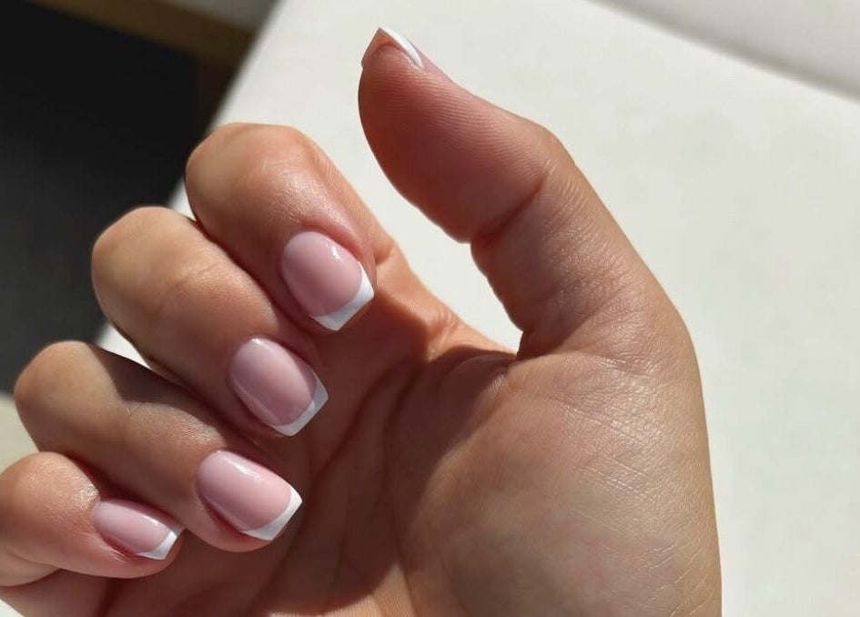 Manicured nails with French tips at Juicy Jels, Melbourne, Victoria, AU, showcasing elegant nail artistry.