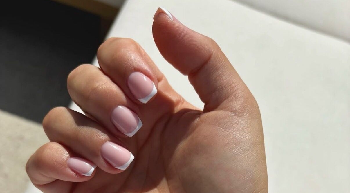 Manicured nails with French tips at Juicy Jels, Melbourne, Victoria, AU, showcasing elegant nail artistry.