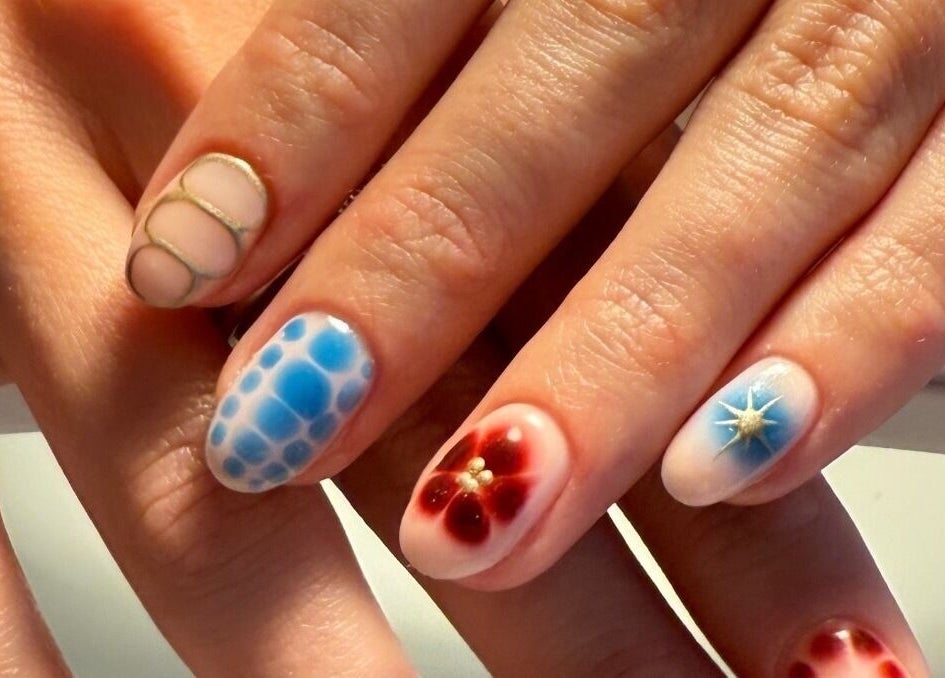 Intricate nail art at Juicy Jels, Melbourne, Victoria, AU featuring vibrant blue and red designs.