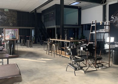 Spacious interior of Sally Mustang Tattoo Joburg in Johannesburg, Gauteng, ZA, with stylish seating and decor.