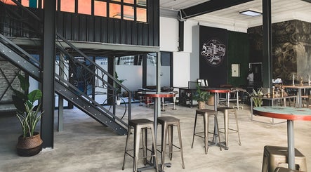 Stylish interior of Sally Mustang Tattoo Joburg, showcasing a modern industrial design in Johannesburg, Gauteng, ZA.