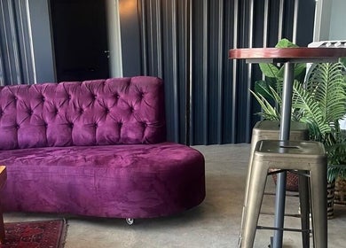 Purple sofa in modern decor at Sally Mustang Tattoo Joburg, Johannesburg, Gauteng, ZA.