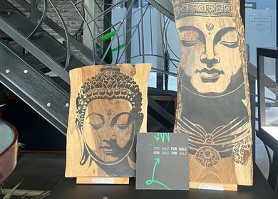 Buddha carvings at Sally Mustang Tattoo Joburg, Johannesburg, Gauteng, ZA, showcasing artistic tranquility.