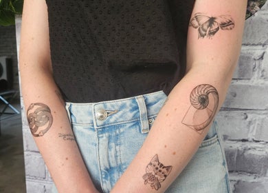 Unique tattoos on arms at Sally Mustang Tattoo Joburg, Johannesburg, Gauteng, ZA, showcasing artistry and design.