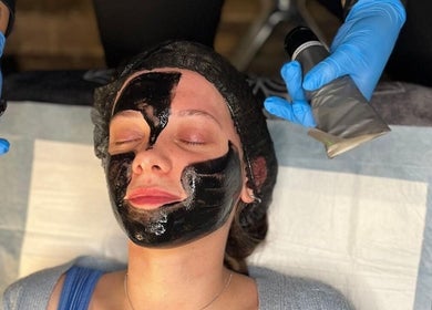 Facial treatment at Sally Mustang Tattoo Joburg, Johannesburg, Gauteng, ZA enhances natural beauty with a black mask.