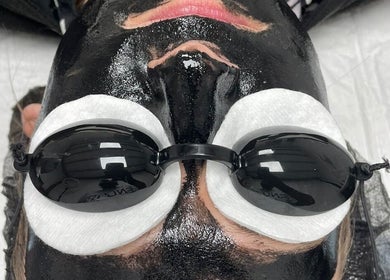 Close-up of facial with black mask at Sally Mustang Tattoo Joburg, Johannesburg, Gauteng, ZA.