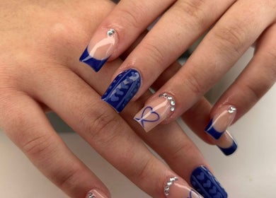 Elegant blue nail art with rhinestones at MISSY Aesthetics & Gals in Douglas, Douglas, IM.