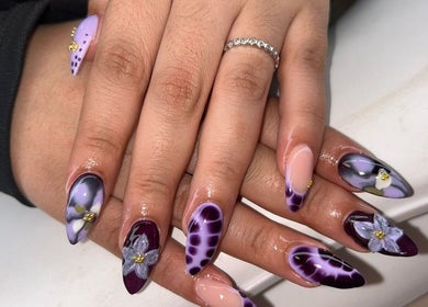 Elegant nail art at MISSY Aesthetics & Gals, Douglas, Douglas, IM, showcasing intricate floral designs.