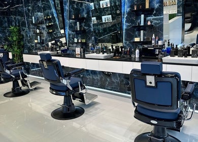 Sleek interior of Fresh Fades Mens Barbershop in Dubai, Dubai, AE, featuring modern barber chairs and polished decor.