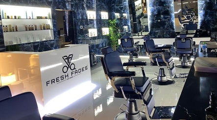 Interior of Fresh Fades Mens Barbershop in Dubai, AE, featuring sleek chairs and modern decor.