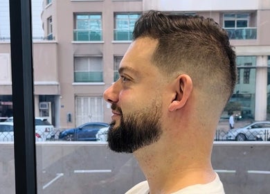 Side profile of a man with a stylish fade haircut at Fresh Fades Mens Barbershop, Dubai, Dubai, AE.