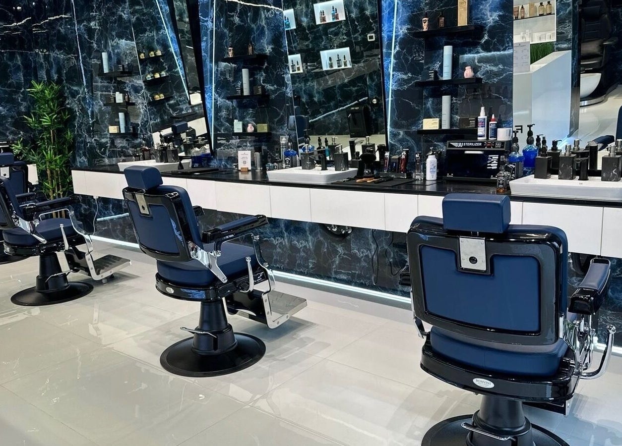 Stylish interior of Fresh Fades Mens Barbershop featuring modern chairs and decor in Dubai, Dubai, AE.