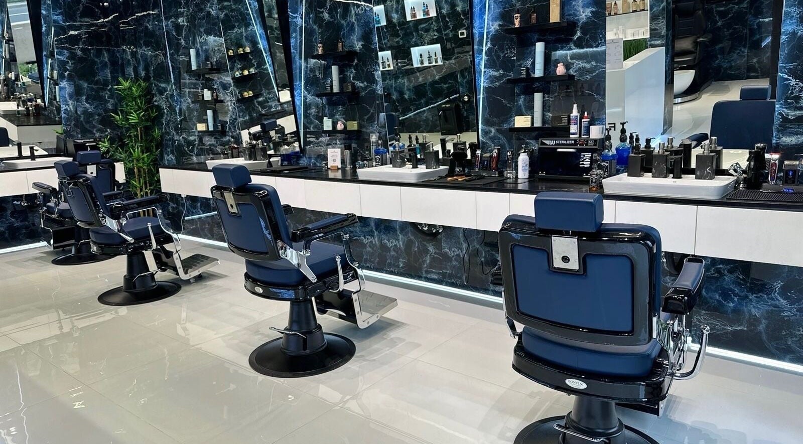 Stylish interior of Fresh Fades Mens Barbershop featuring modern chairs and decor in Dubai, Dubai, AE.