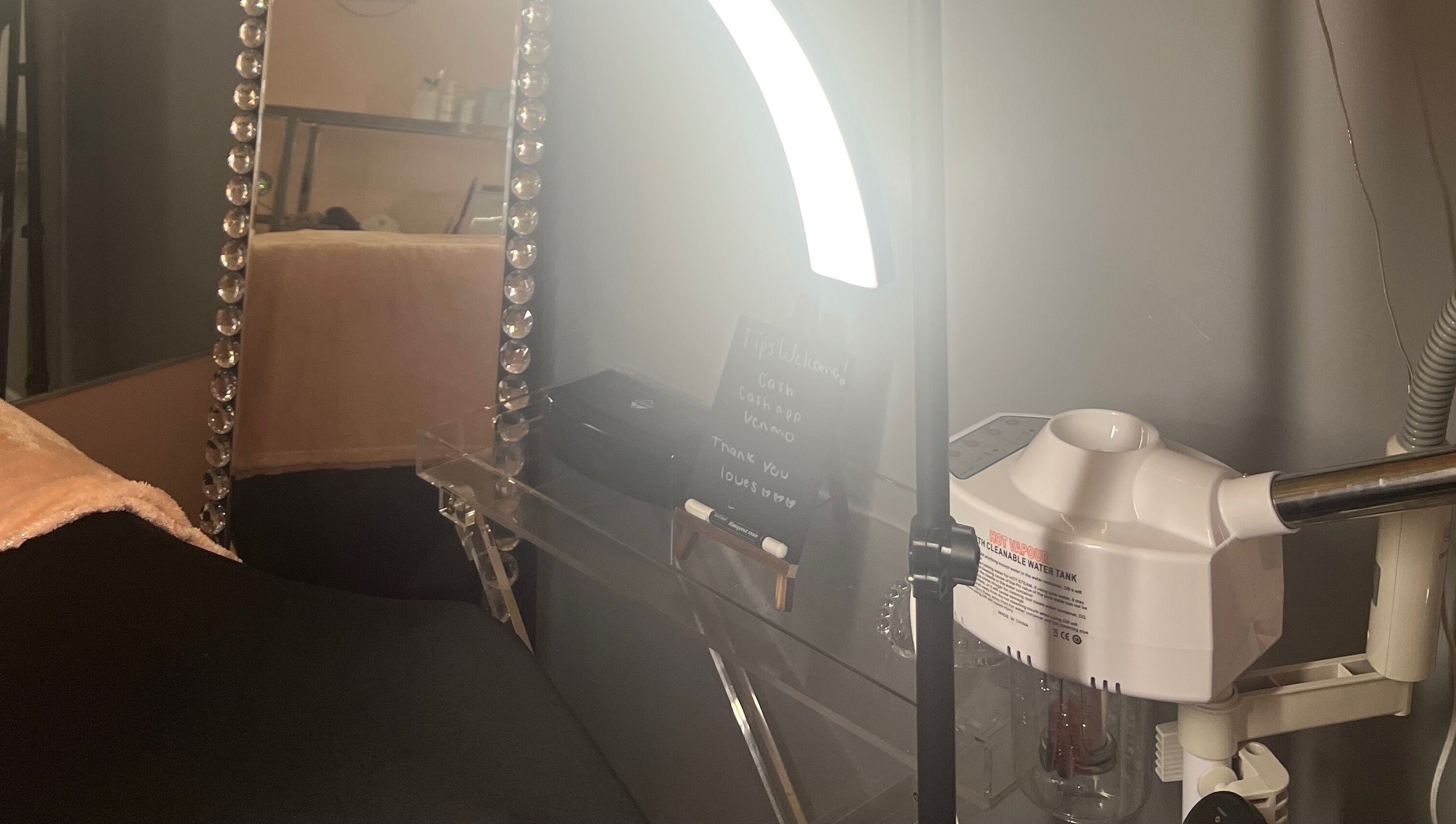 Beauty station at Filtrdxrosy, Boston, Massachusetts, US with mirror, lights, and equipment.