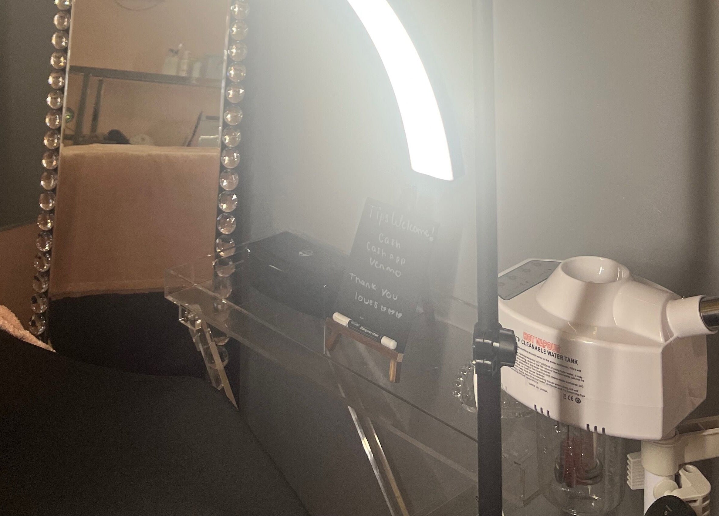 Beauty station at Filtrdxrosy, Boston, Massachusetts, US with mirror, lights, and equipment.