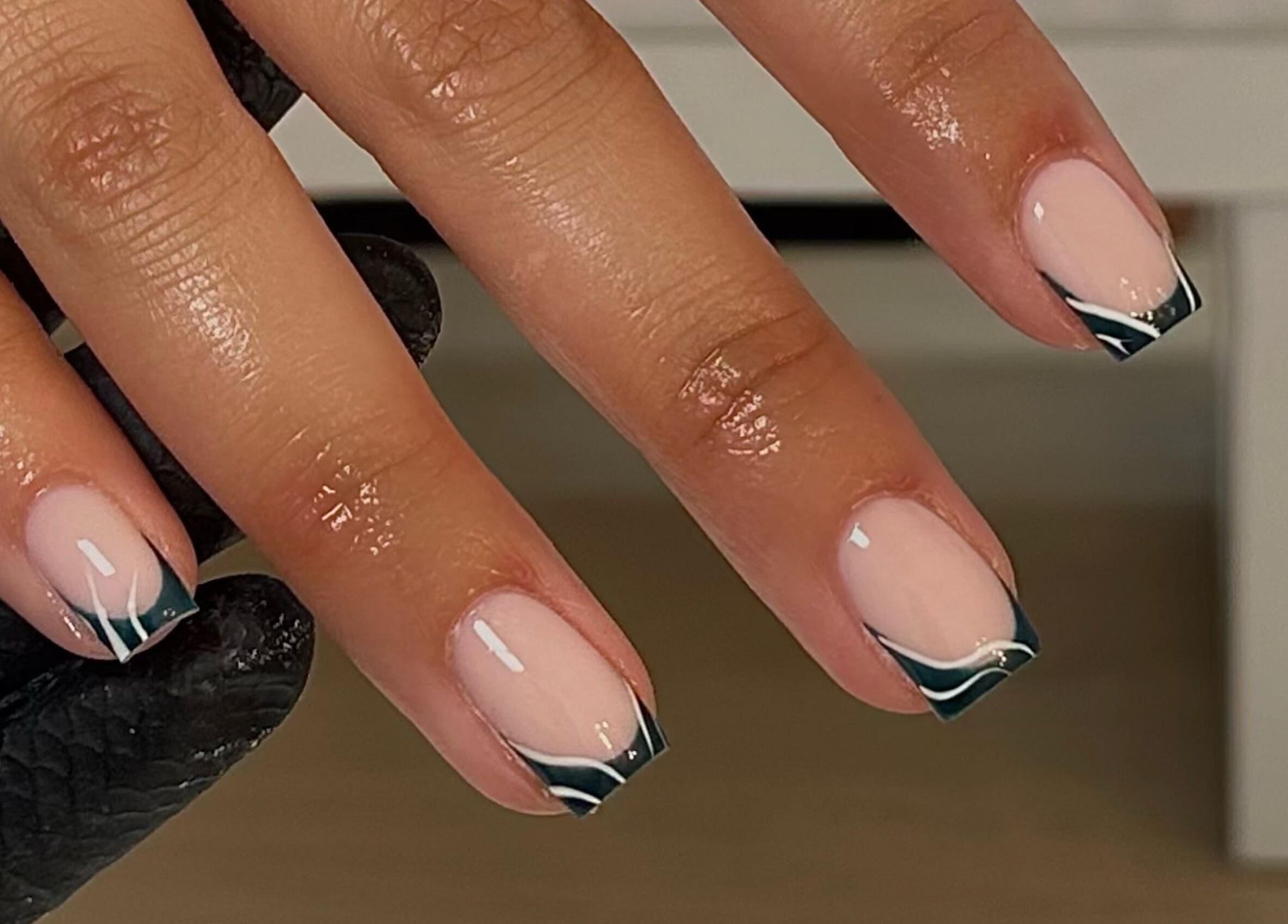 Manicured nails with black tips at A.B Studio, Cardiff, Wales, GB.