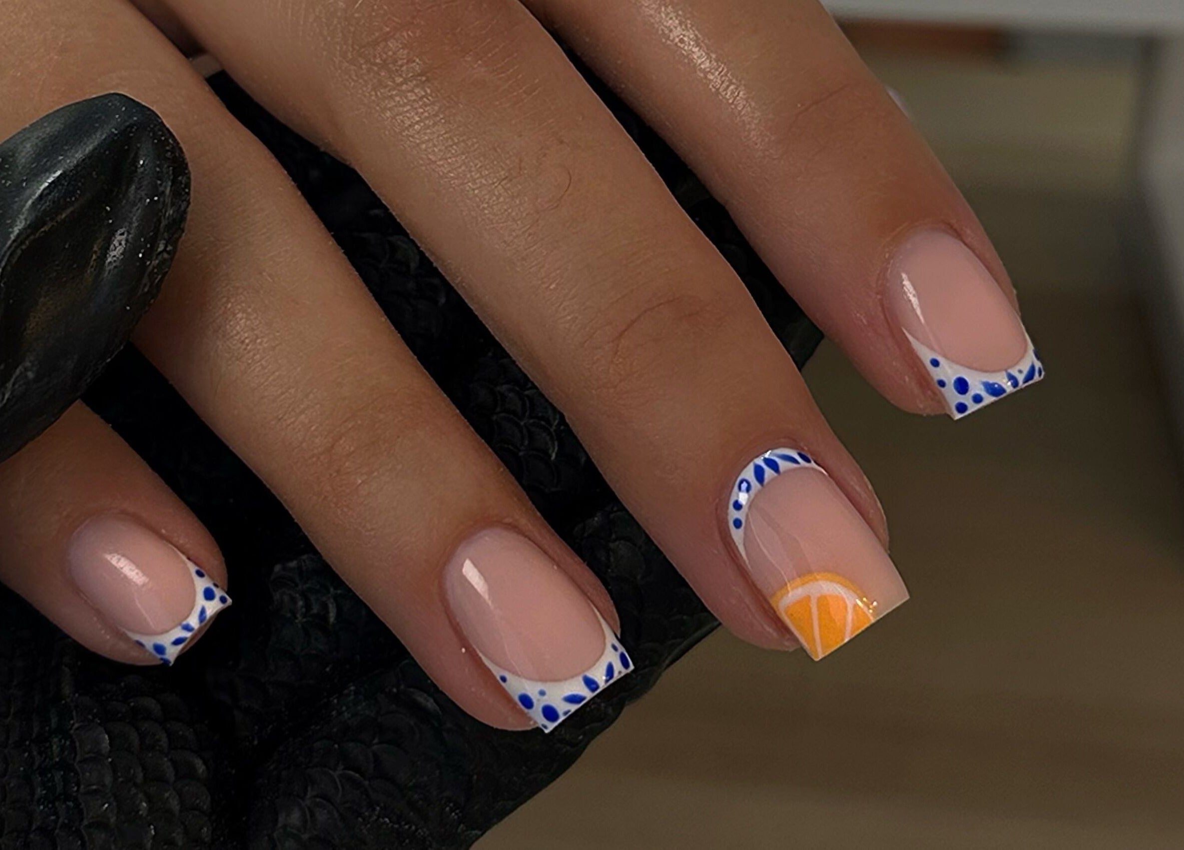 Creative nail design with blue and orange art at A.B Studio, Cardiff, Wales, GB.