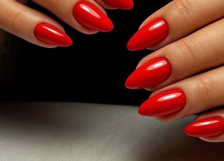 Stunning red manicure by Nel Nails in Aughnacloy, Northern Ireland, GB. Perfectly shaped with a glossy finish.