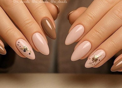 Elegant nail design at Nel Nails, Aughnacloy, Northern Ireland, GB with gold accents on neutral tones.