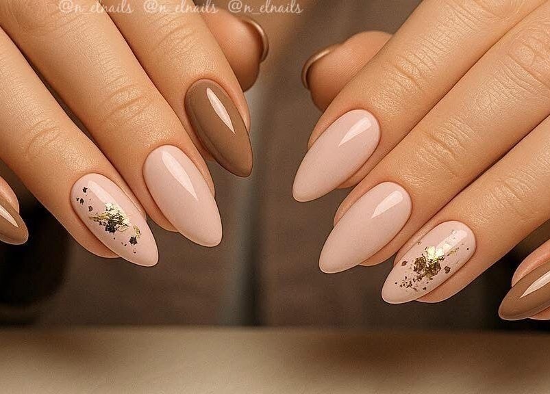 Elegant nail design at Nel Nails, Aughnacloy, Northern Ireland, GB with gold accents on neutral tones.