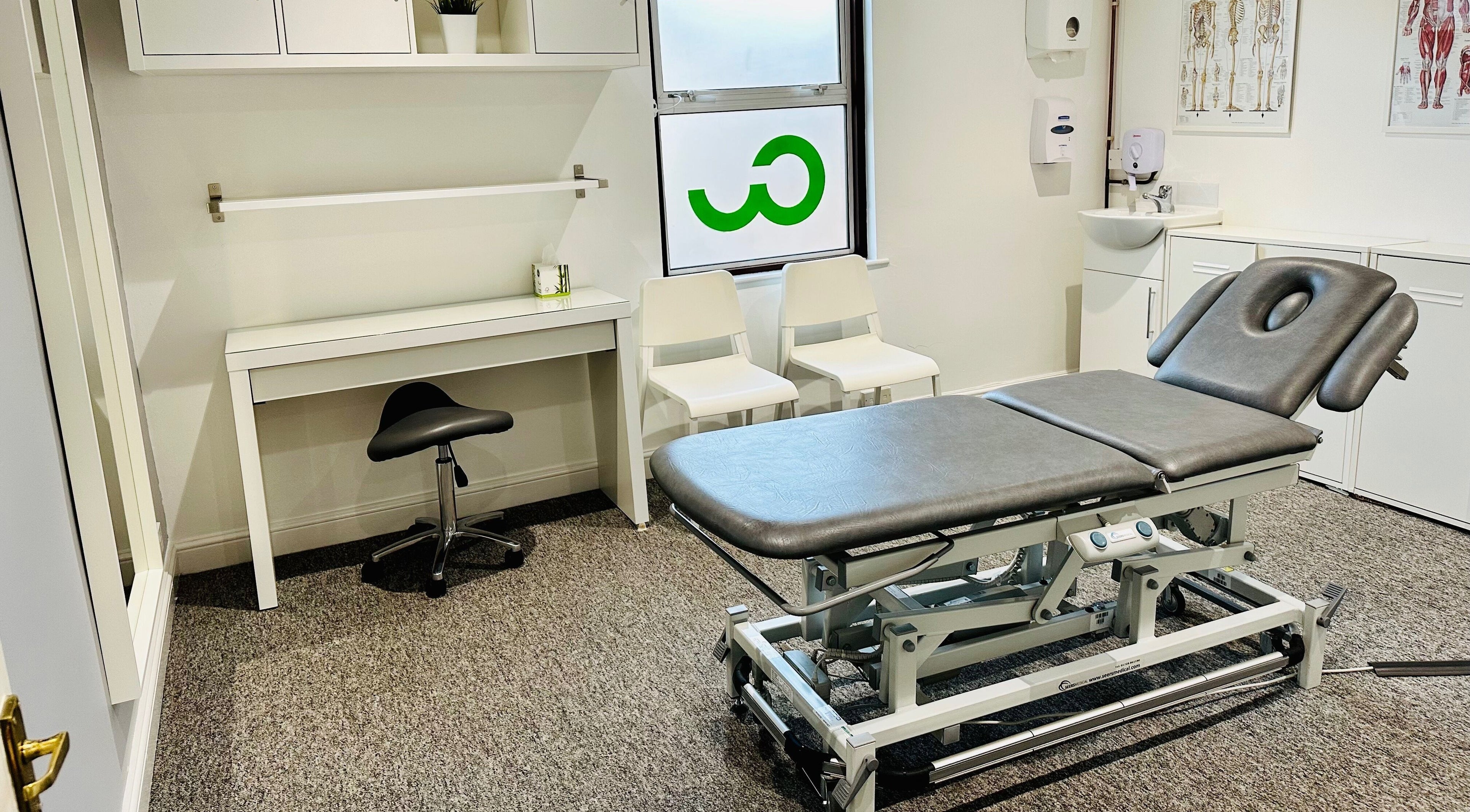 Spa room at CW Therapy Rooms in Kenilworth, England, GB with a massage table and stylish decor.