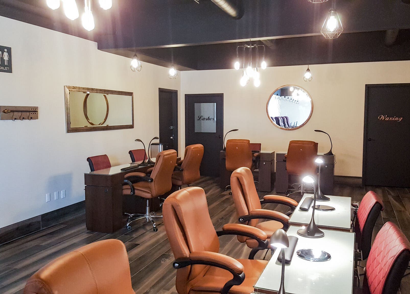 Elegant Nails and Spa in London, Ontario, CA features a modern, well-lit salon interior with leather seating.