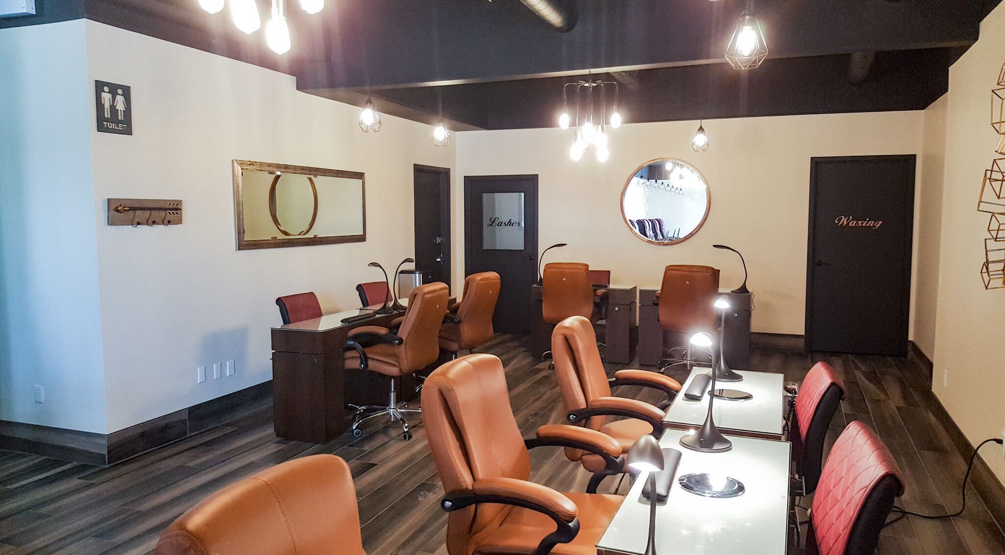 Elegant Nails and Spa in London, Ontario, CA features a modern, well-lit salon interior with leather seating.