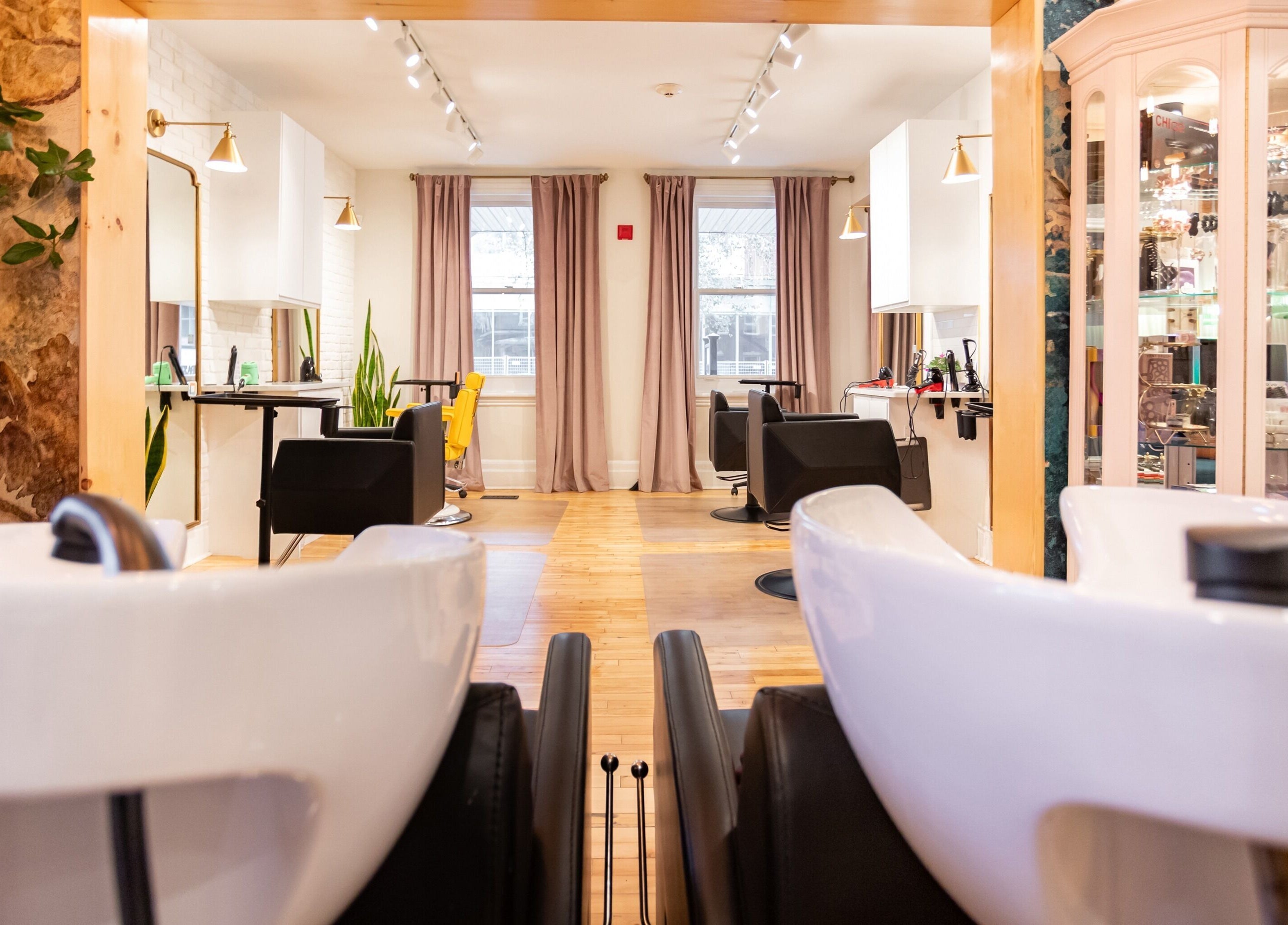 Intérieur chic de Spazio Design Capillaire à Gatineau, Québec, CA, avec fauteuils et éclairage doux.