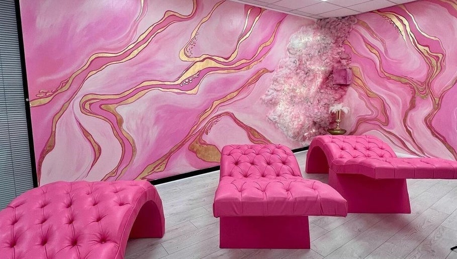 Luxurious pink lounge area at By Beauty Academy, Manchester, England, GB with chic furnishings and vibrant decor.